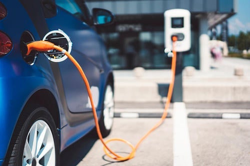 An electric vehicle at a charging station.