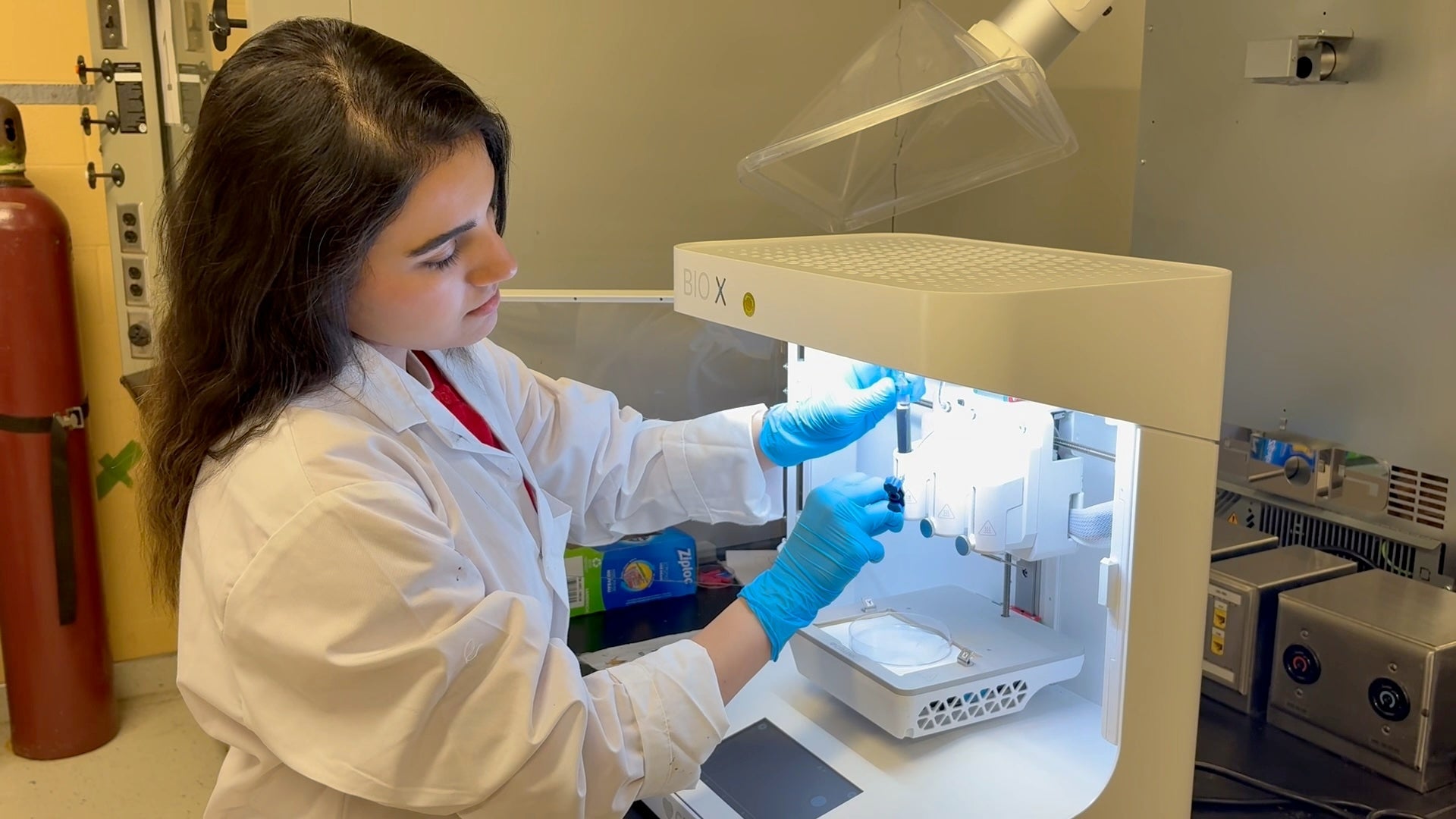 Chemical Engineering PhD student Shakiba Samsami loading the graphene ink into the 3D printer.