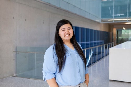 Guia Pucyutan standing in front of QNC staircase