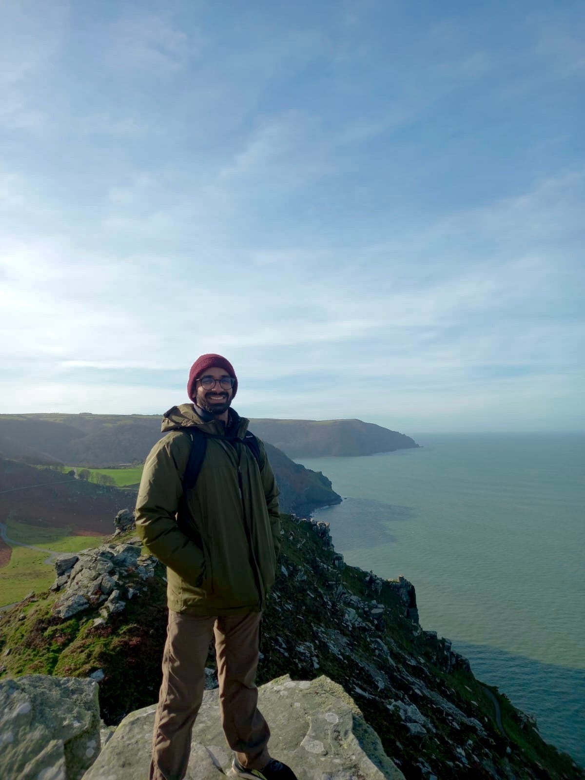 Narayan Subramoniam smiling on a hill while hiking