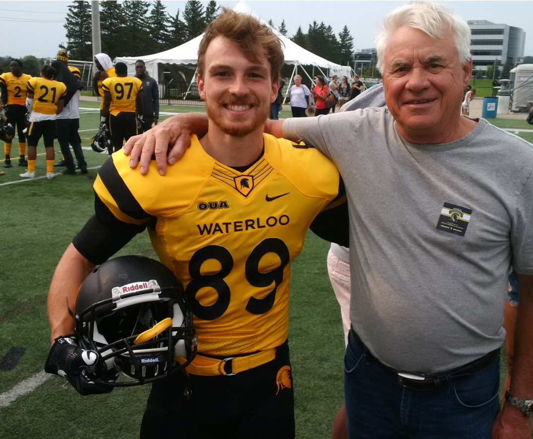 MacNaughton with a football scholarship recipient.