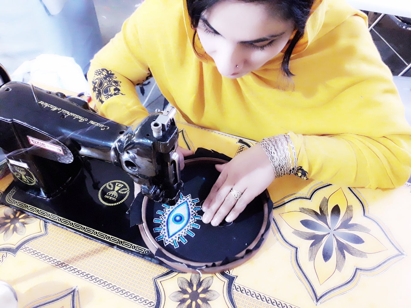 Afghan woman making embordiered patches