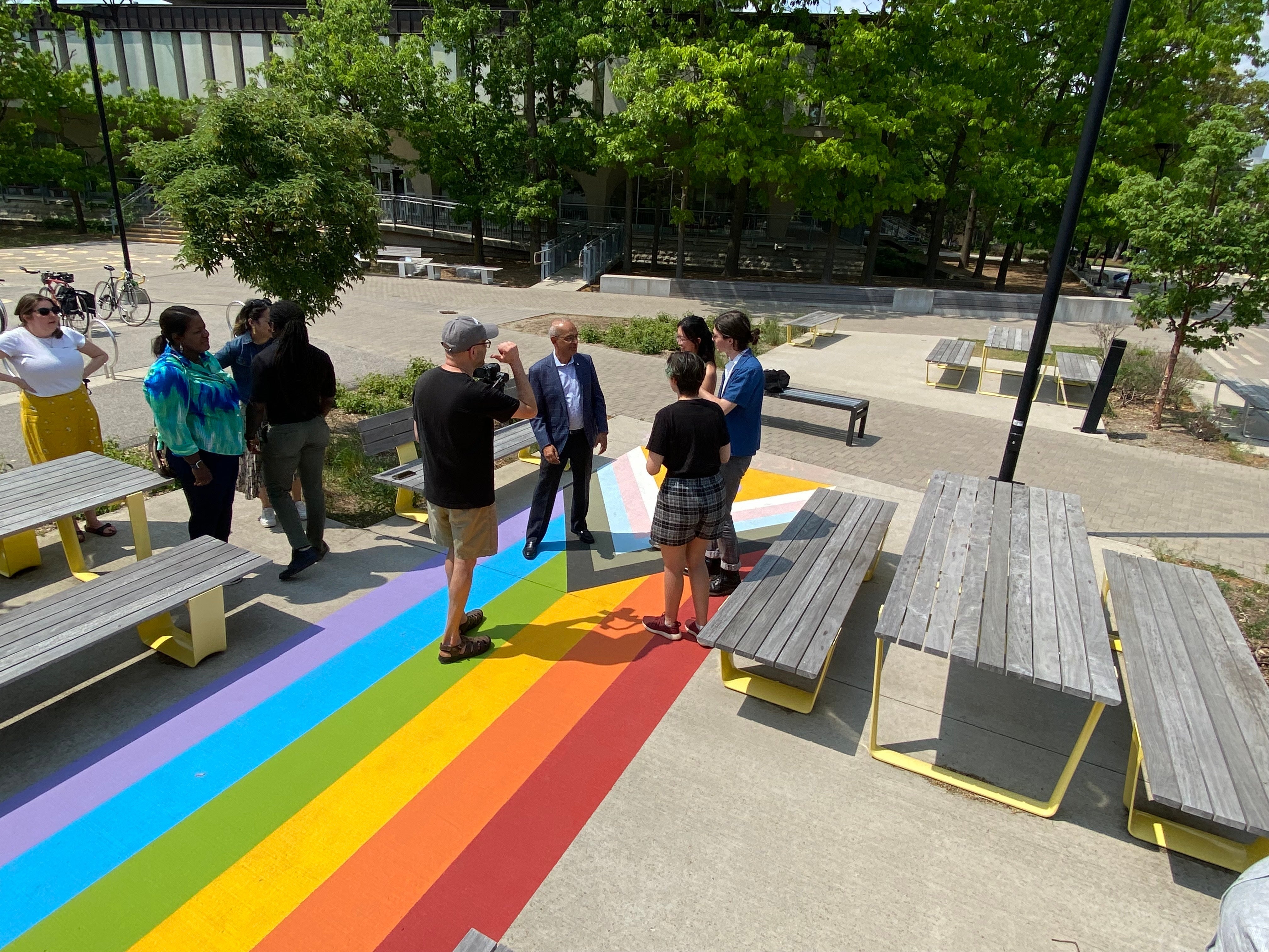 People hanging around a Pride crosswalk