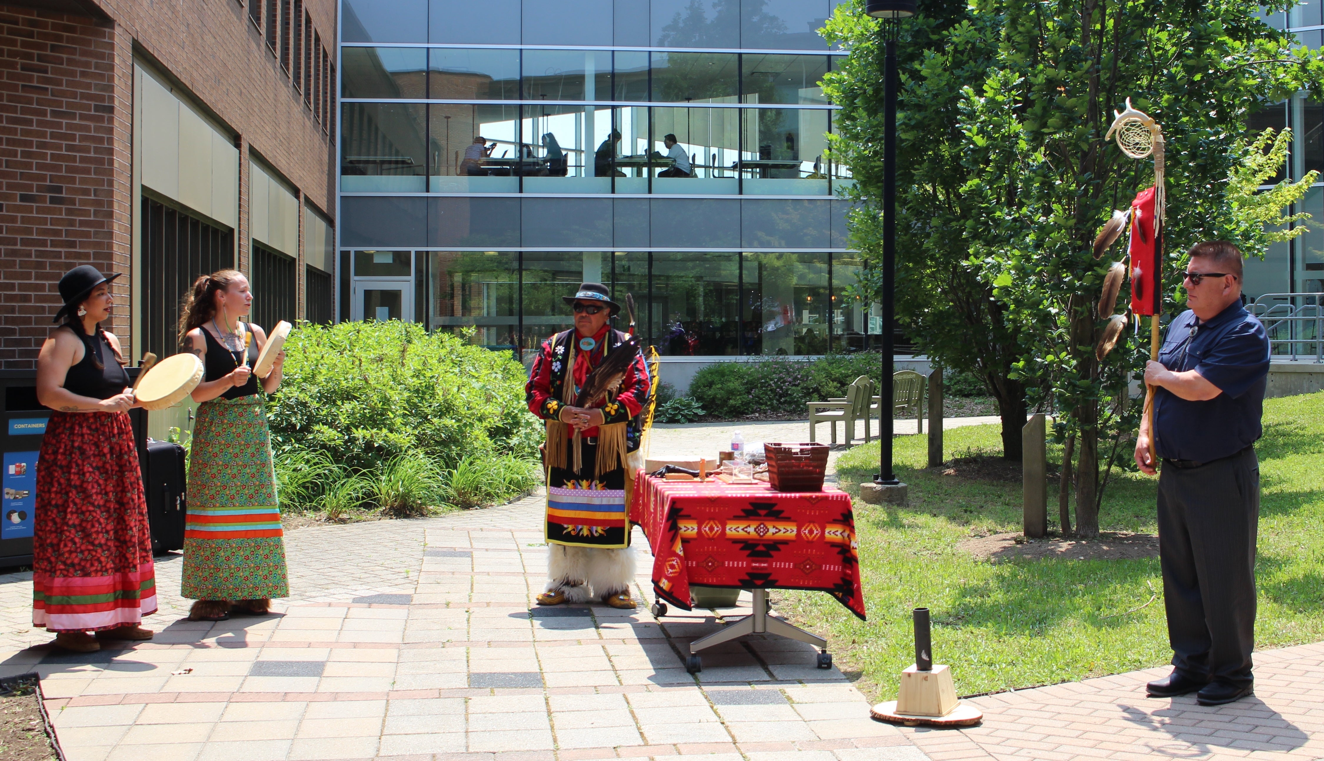 Drum group, Elder Henry and Glen Henhawk in courtyard