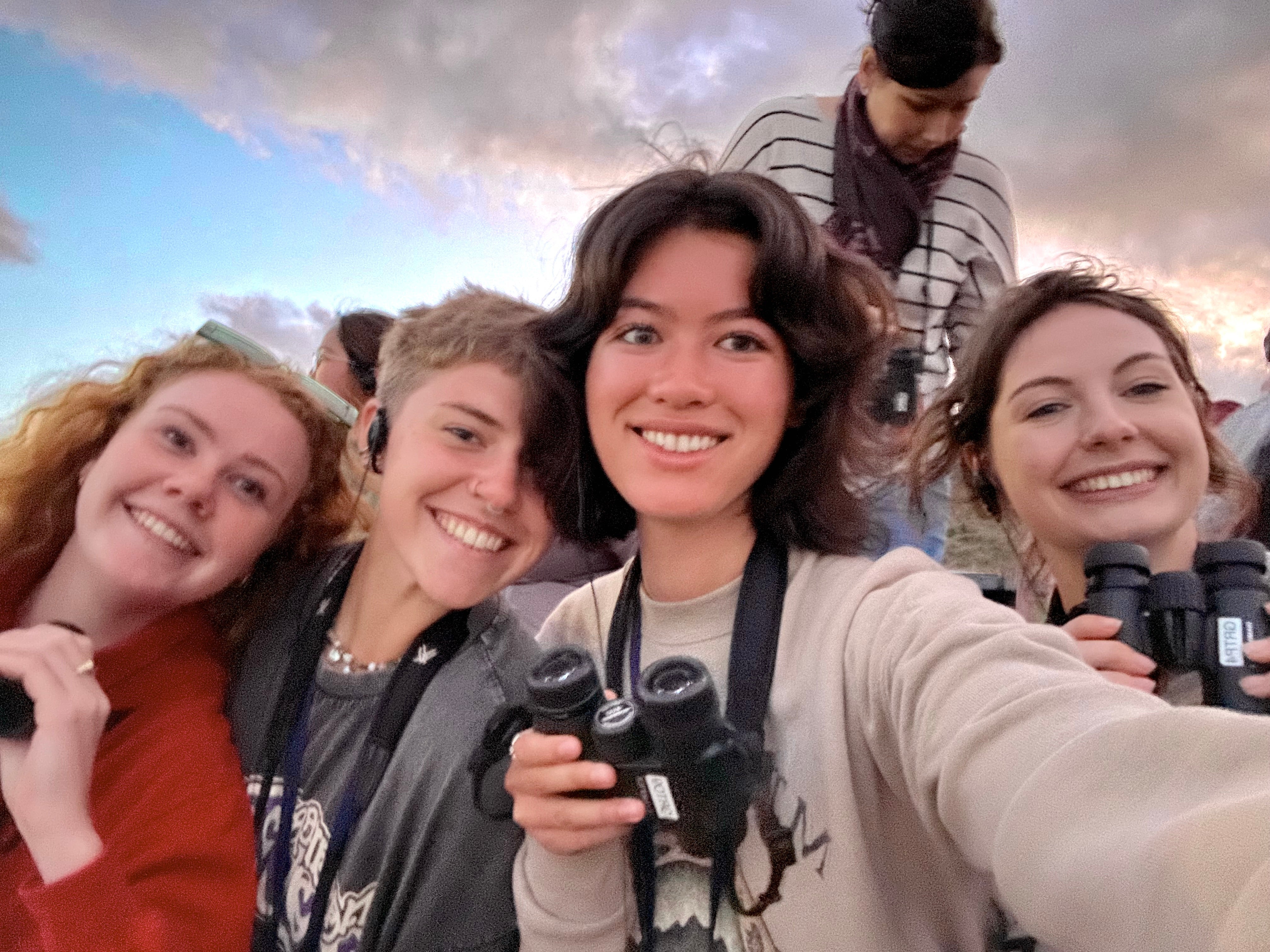 Rachel Butler takes a selfie with a group of friends while hiking