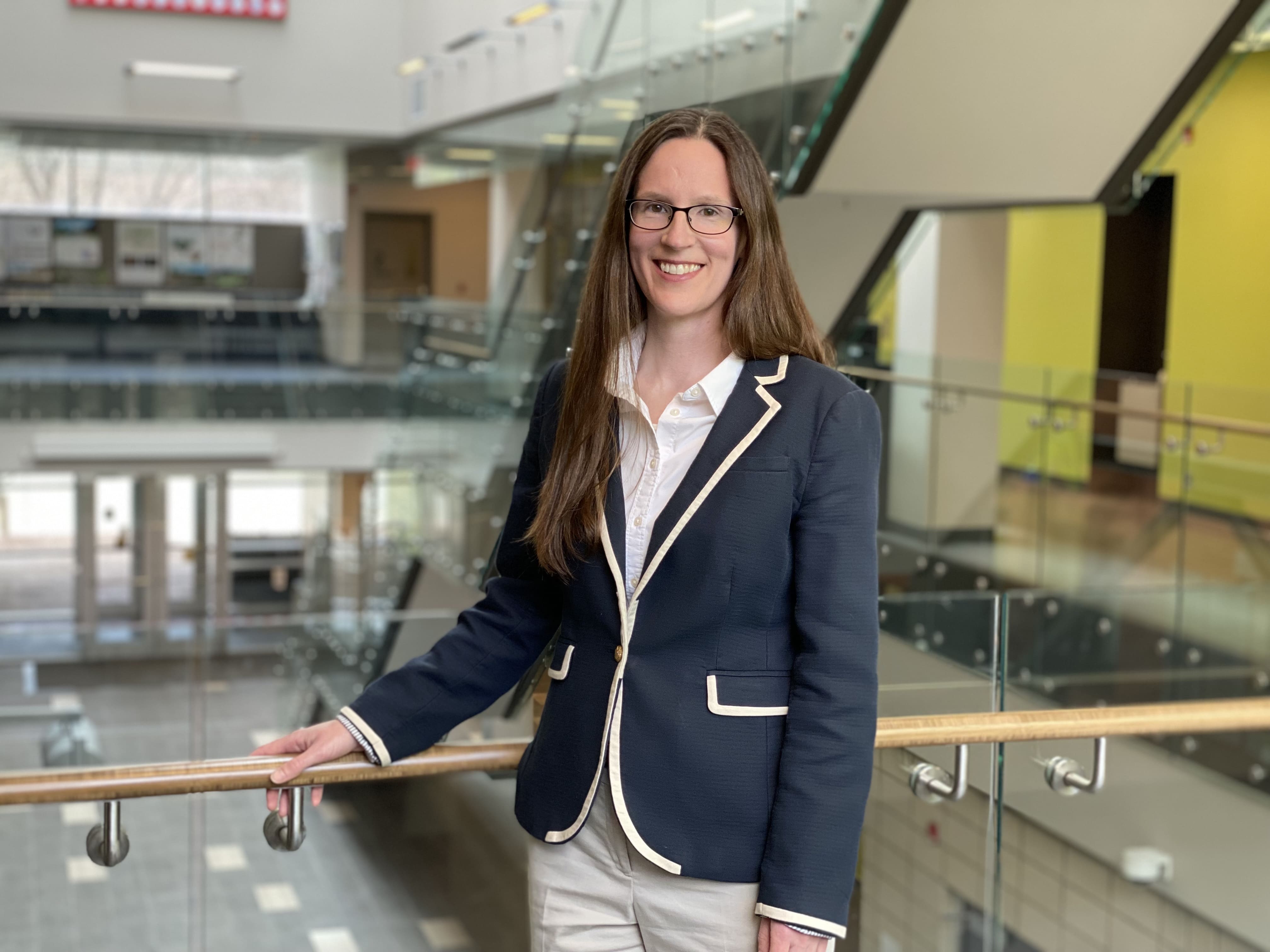 Dr. Rebecca Saari standing beside a railing