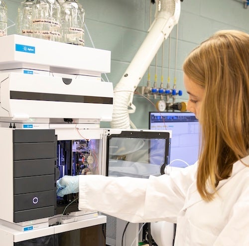 Student in lab using equipment
