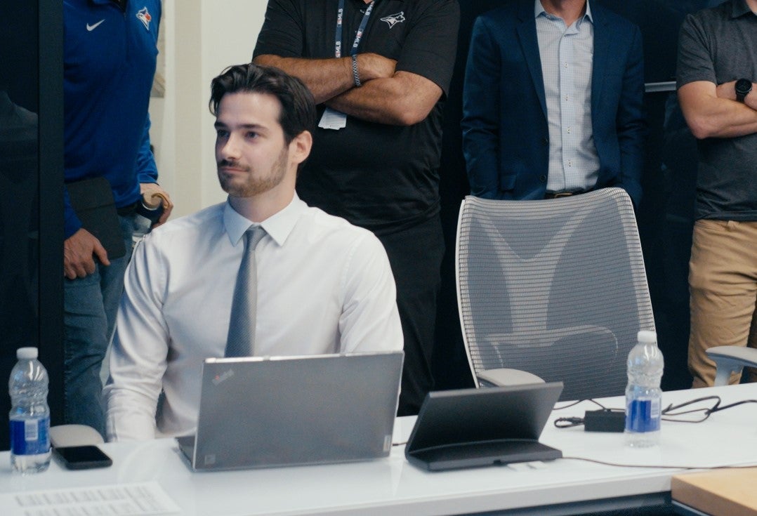 Jesse sits at his computer inside the Blue Jays war room during the 2025 draft.