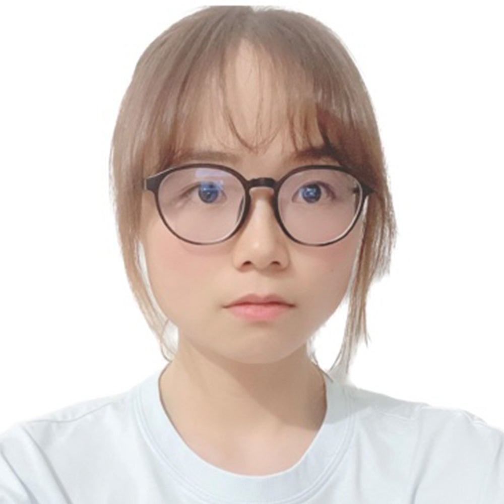 Jing Du looks off camera in front of a white background