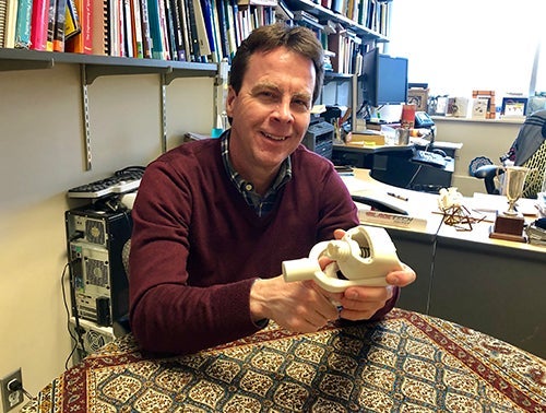 John McPhee holds the curling device.