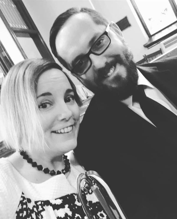 The couple posing in a black and white photo
