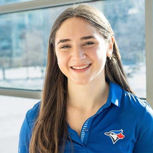 Juliana Bossom poses while wearing a blue jays shirt