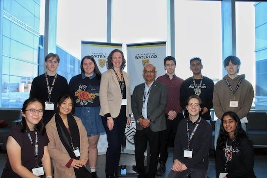 A group of nine students, along with Dr. Vivek Goel and Meghan Moore