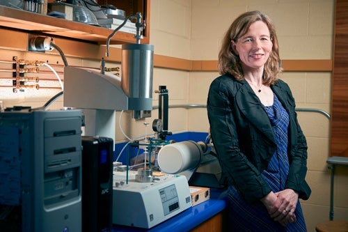 Mary Wells standing next to lab equipment