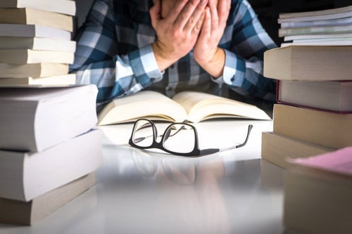 Stressed student with text books