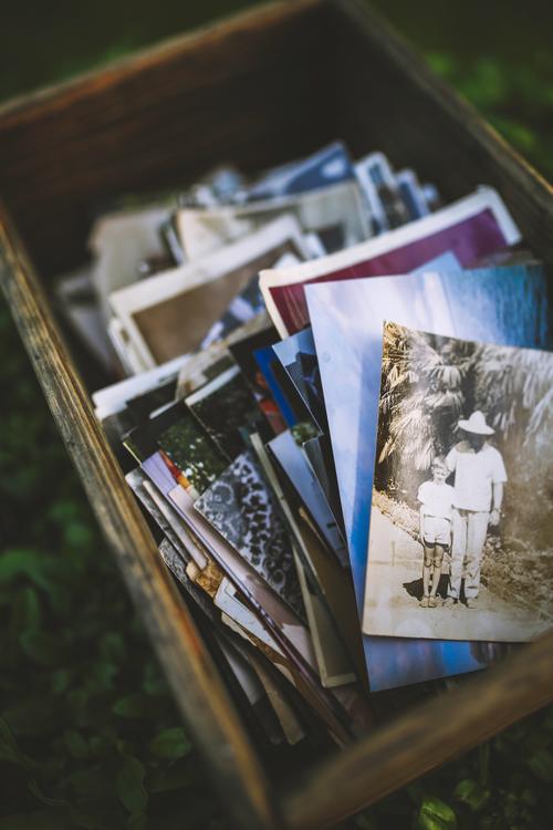 Box of photos with picture of man and boy on top