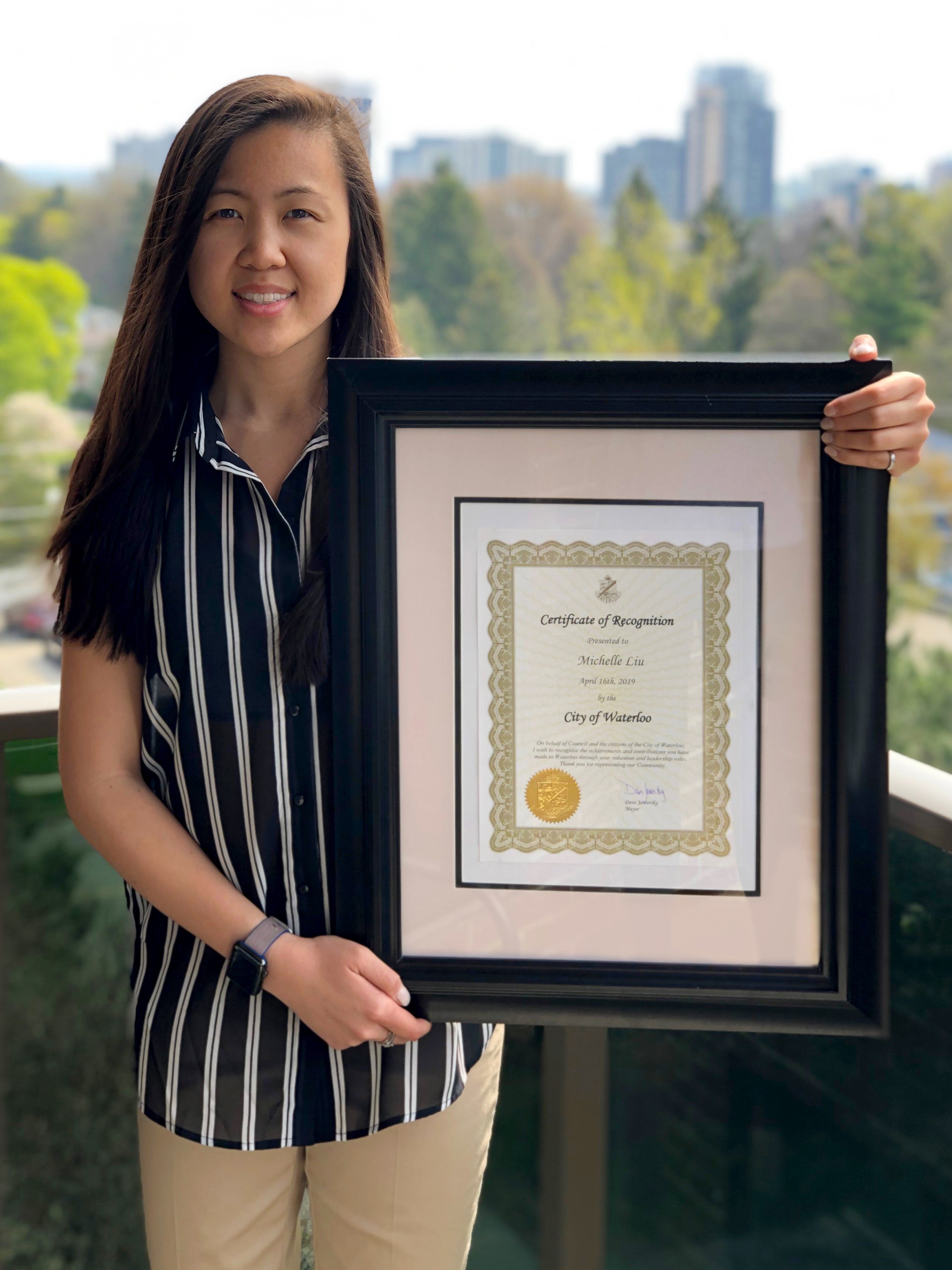 Michelle Liu holding City of Waterloo volunteer certificate