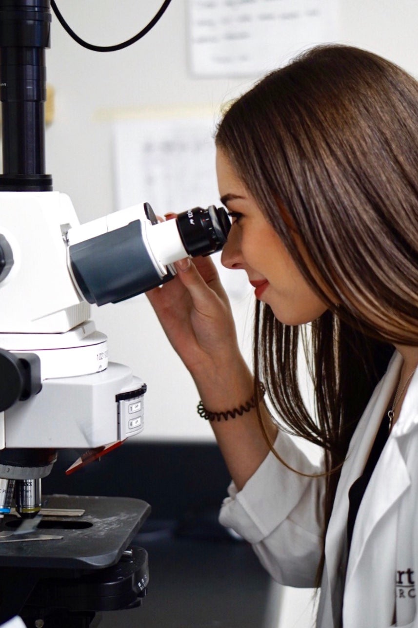 Natasha using microscope