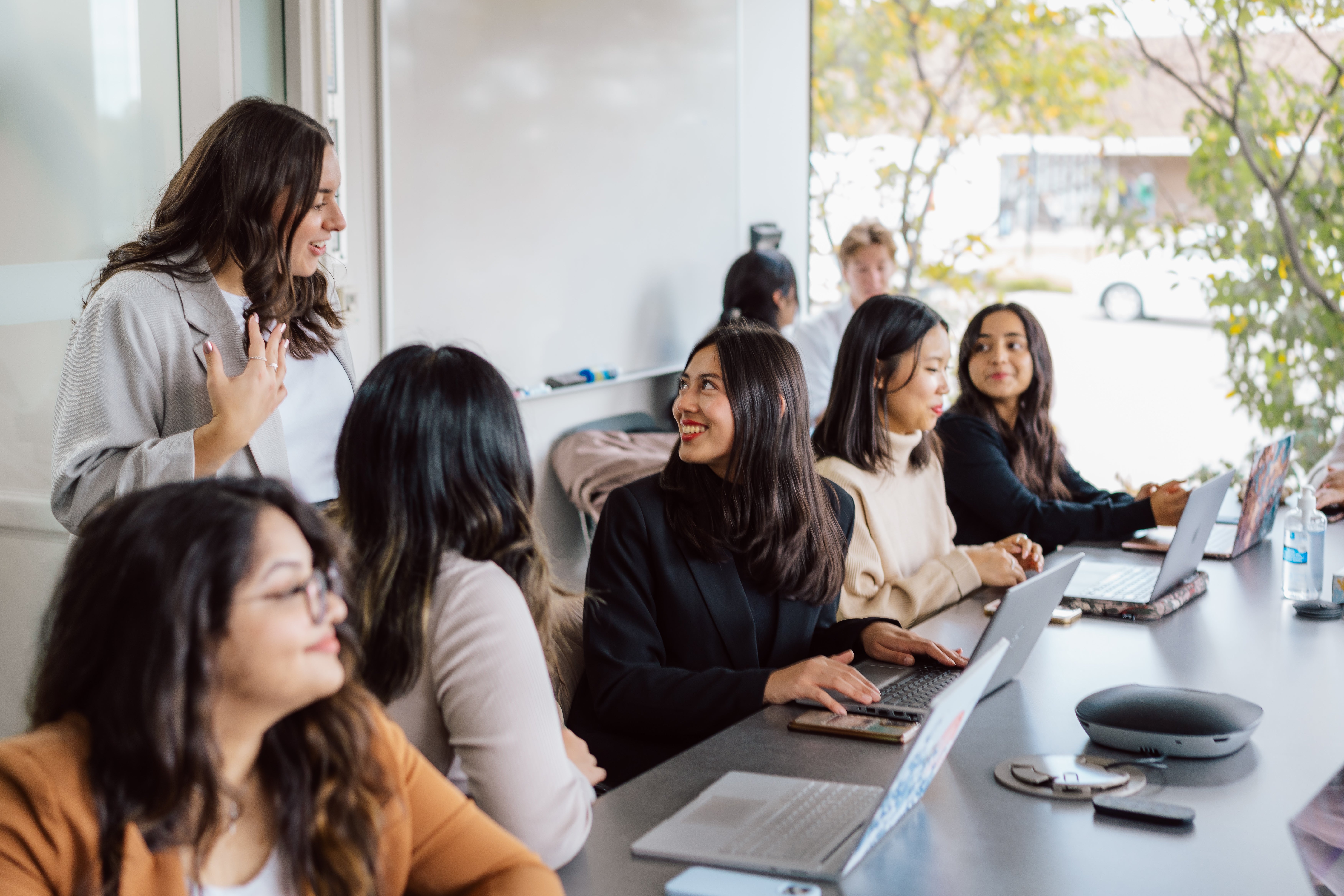 Co-op students seated at a table in a work-integrated learning experience