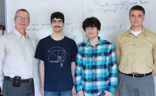 Left to right: Waterloo Dean of Mathematics Ian Goulden, 2014 Waterloo Putnam team members Daniel Spivak and Sam Eisenstat, with coach Professor Stephen New.