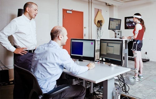 Researchers monitoring standing study participant