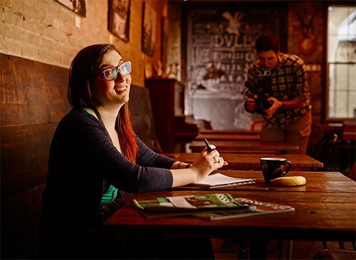 Victoria Stacey sitting at a table in a Waterloo Restaurant