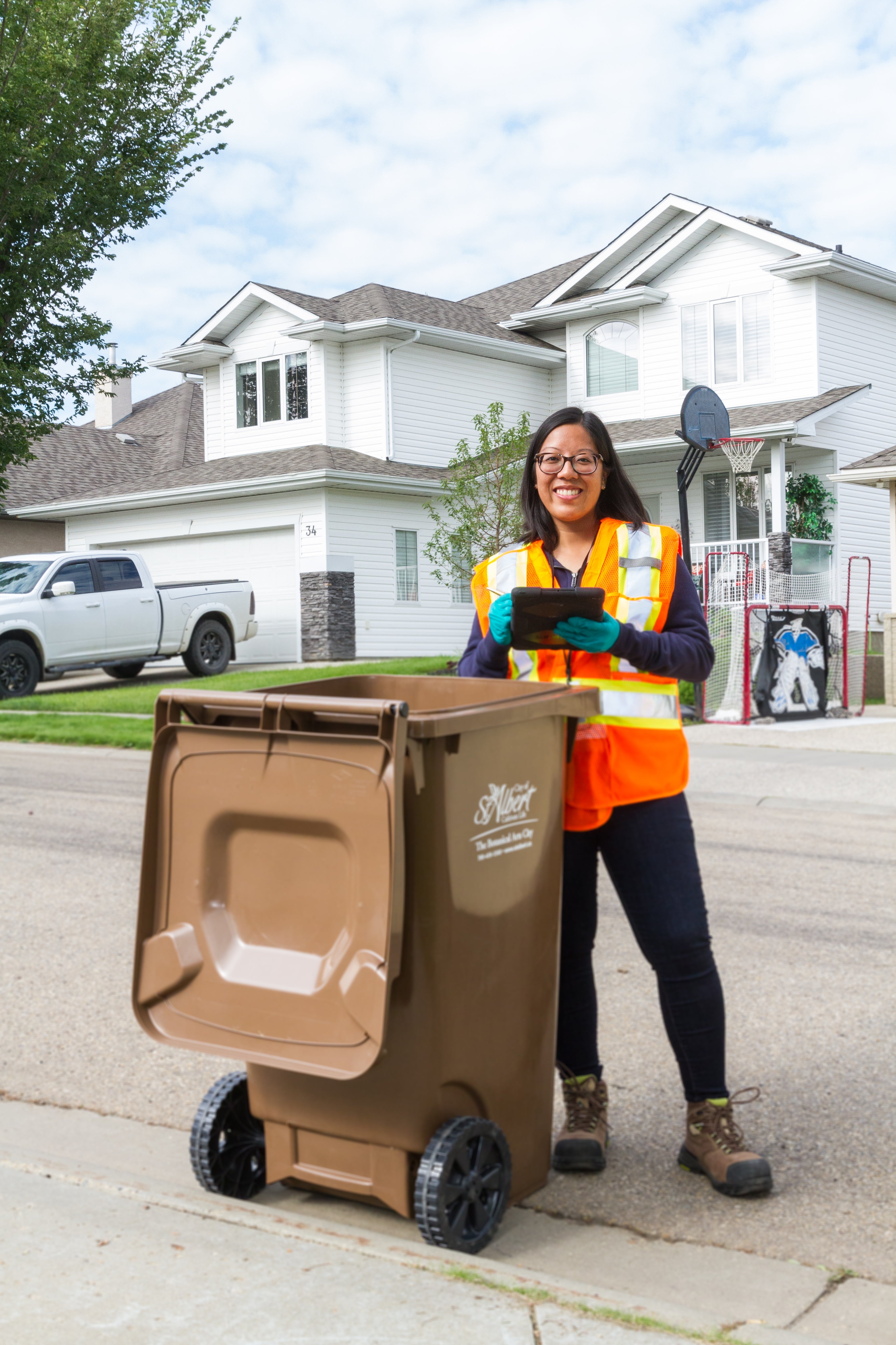 Olivia beside garbage bin