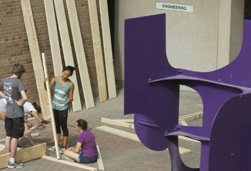 Engineering students building a wall for Orientation