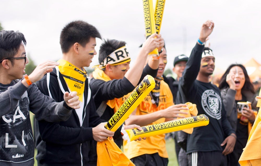 Students wearing black and gold attending an orientation week event