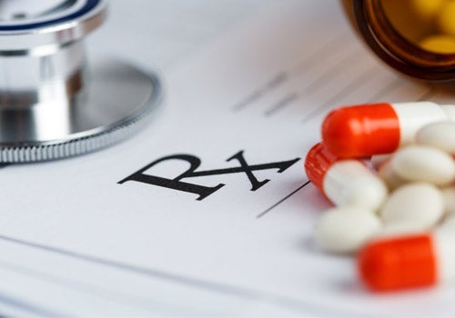 Doctor's prescription pad and medications