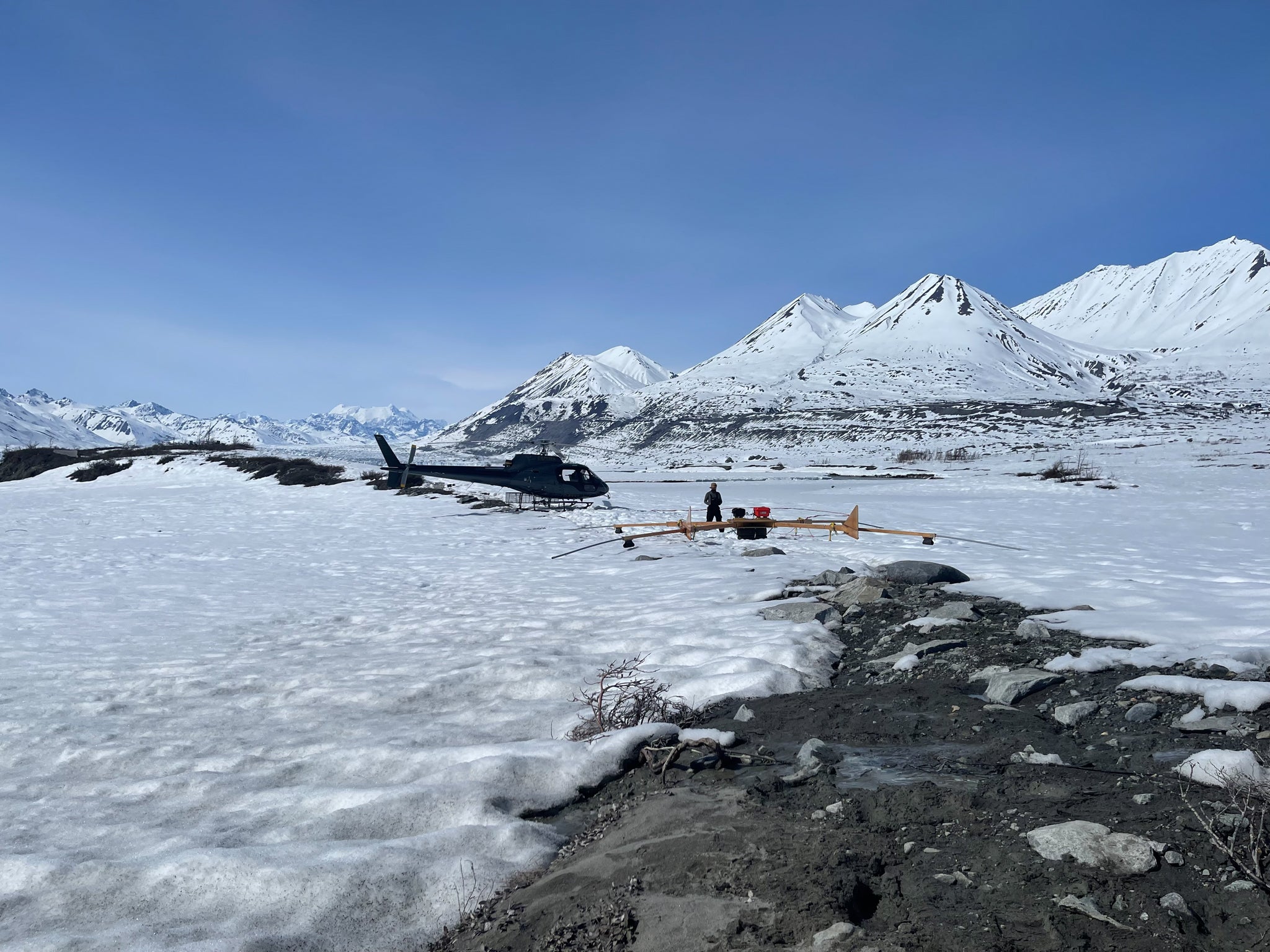 Peter Wray near Lowell Glacier ready to help the helicopter pilot launch the radar system and start a survey