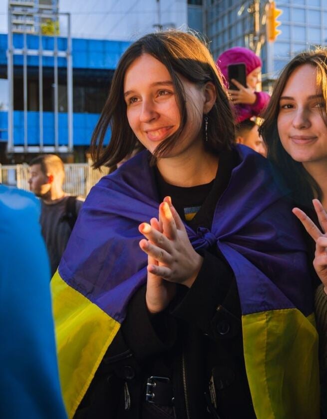 Iovenko at wrapped in a flag at a rally for Ukraine