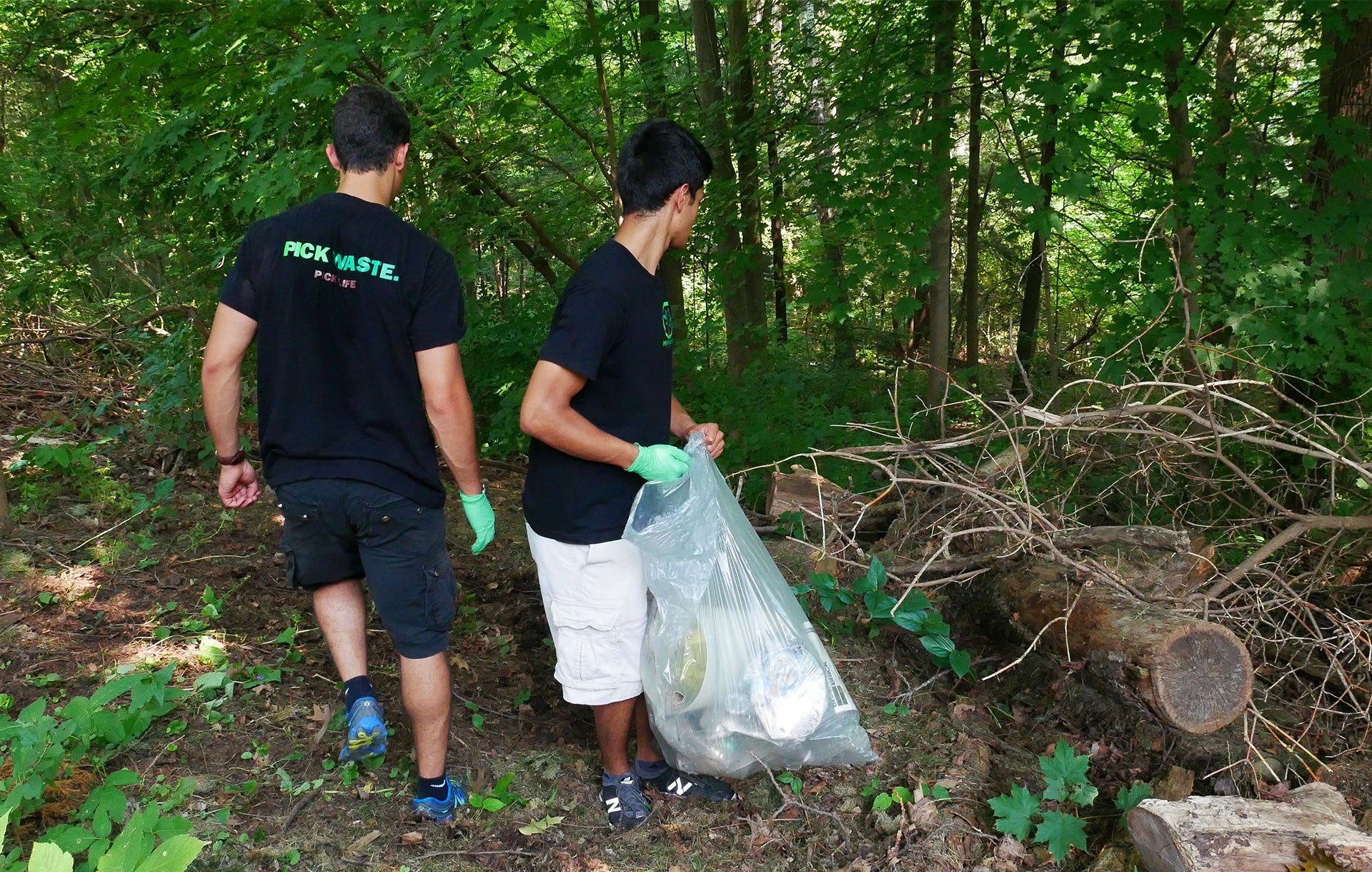 Pickwaste founders next to garbage bags
