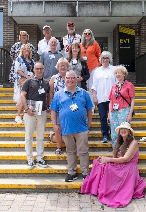 Alumni from the Planning class of '94 posing in front of EV1