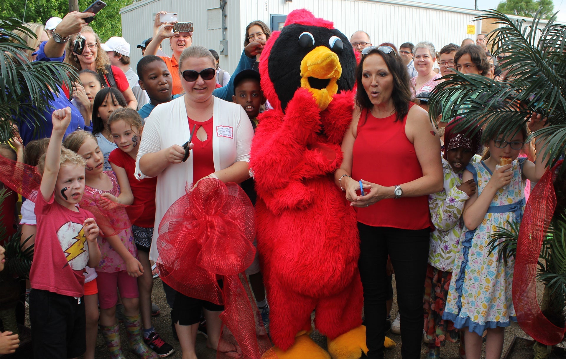 Penny Miller, right, the principal at Keatsway Public School, cuts a ribbon to officially open its new playground structure.