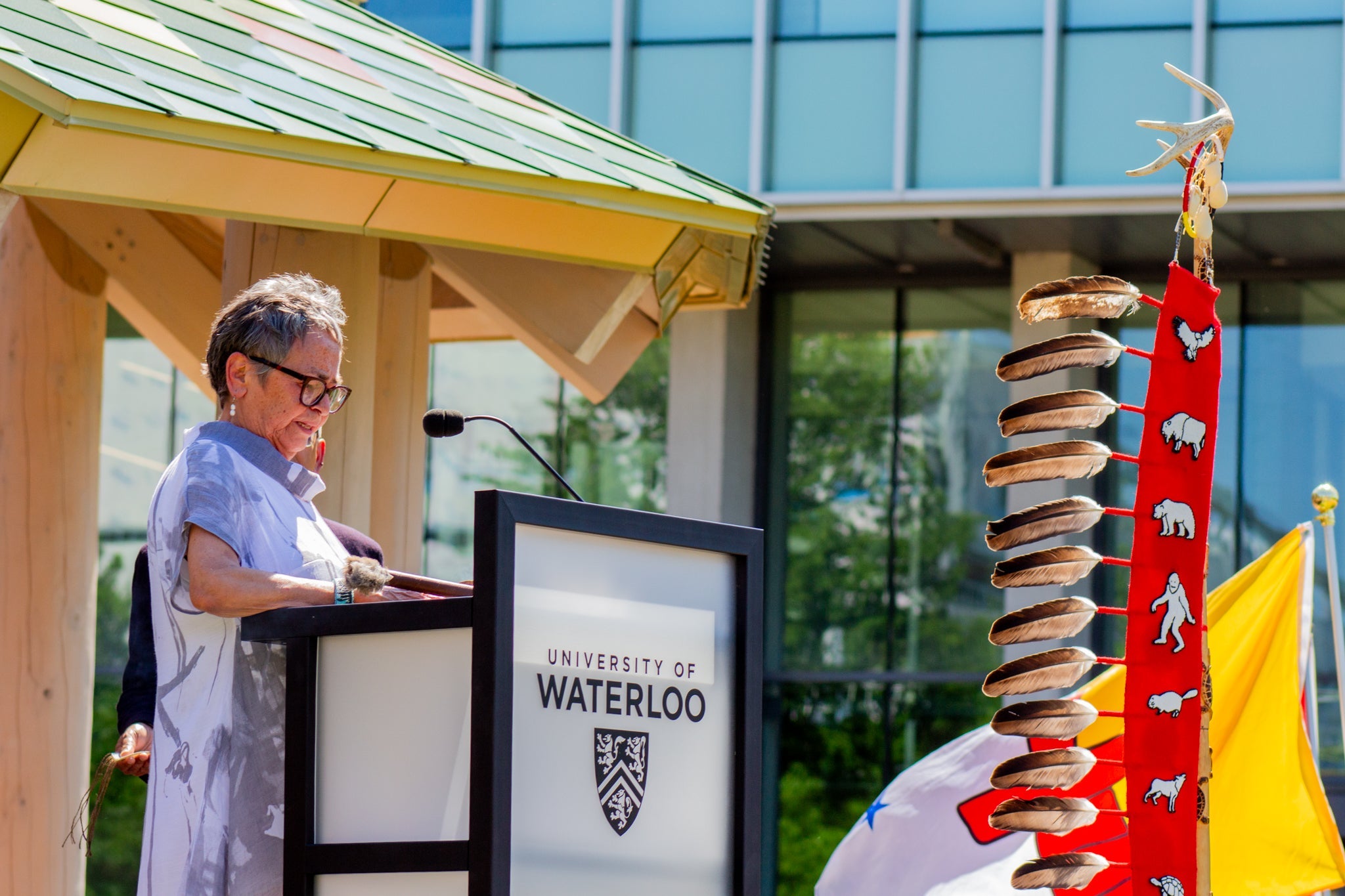 Jean Becker speaks at podium