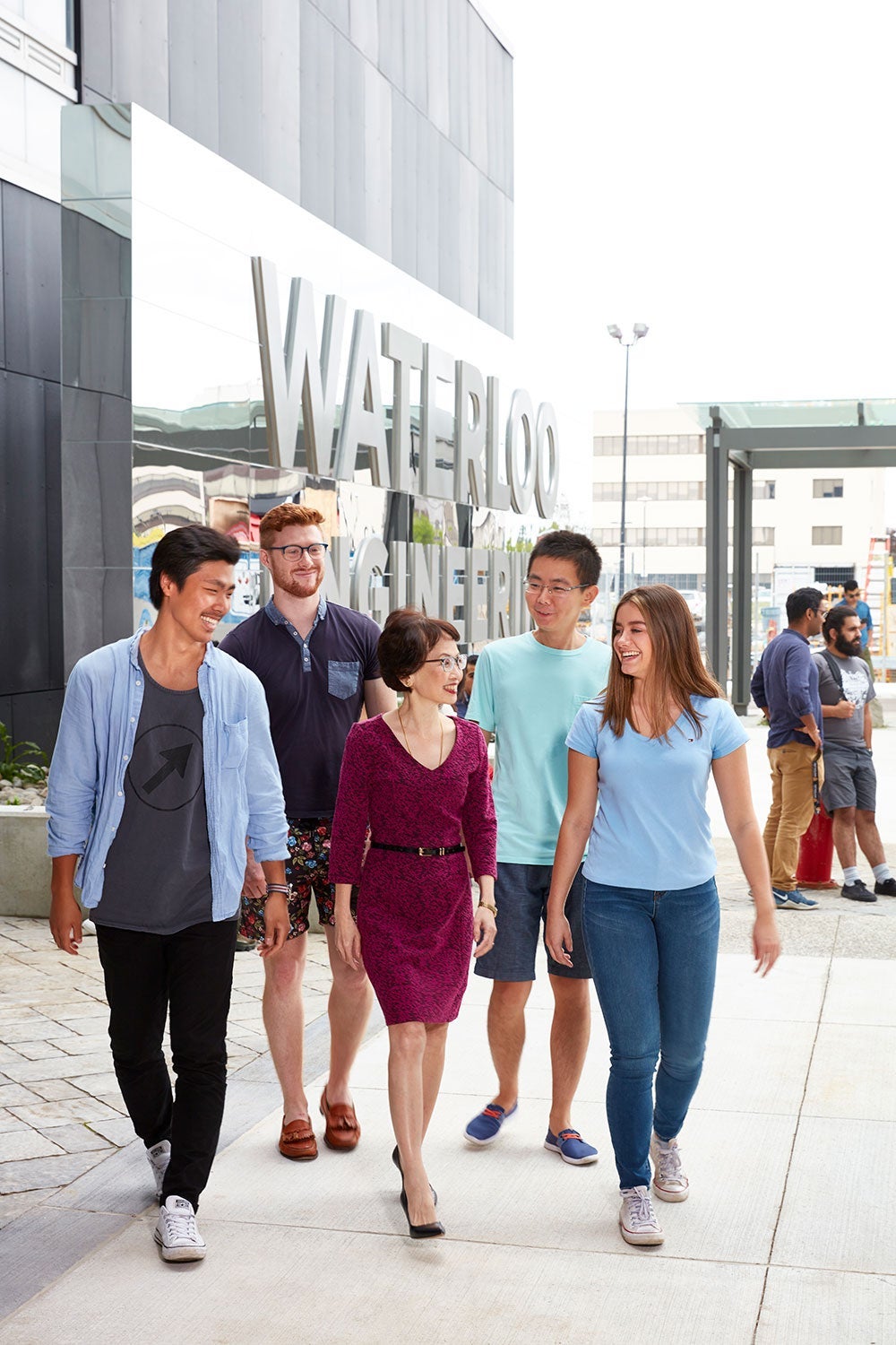 Pearl Sullivan, centre, joins students walking into Engineering 7, a major Educating the Engineer of the Future campaign initiative she led.