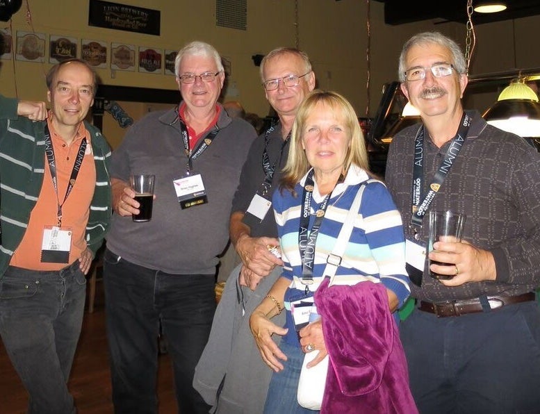 Five alumni posing for a photo at Reunion in 2015