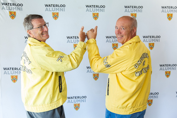 Two alum wearing old University of Waterloo jackets