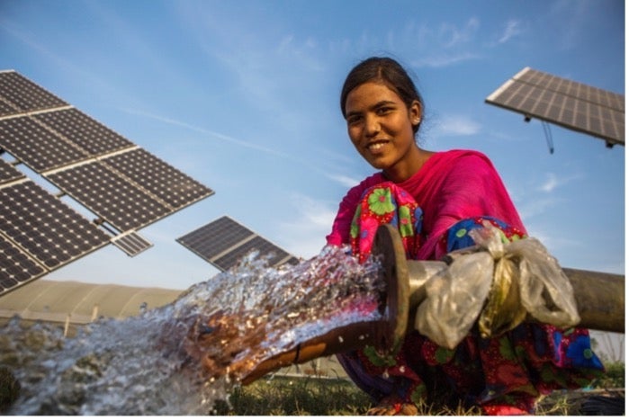 Woman holding a groundwater pump