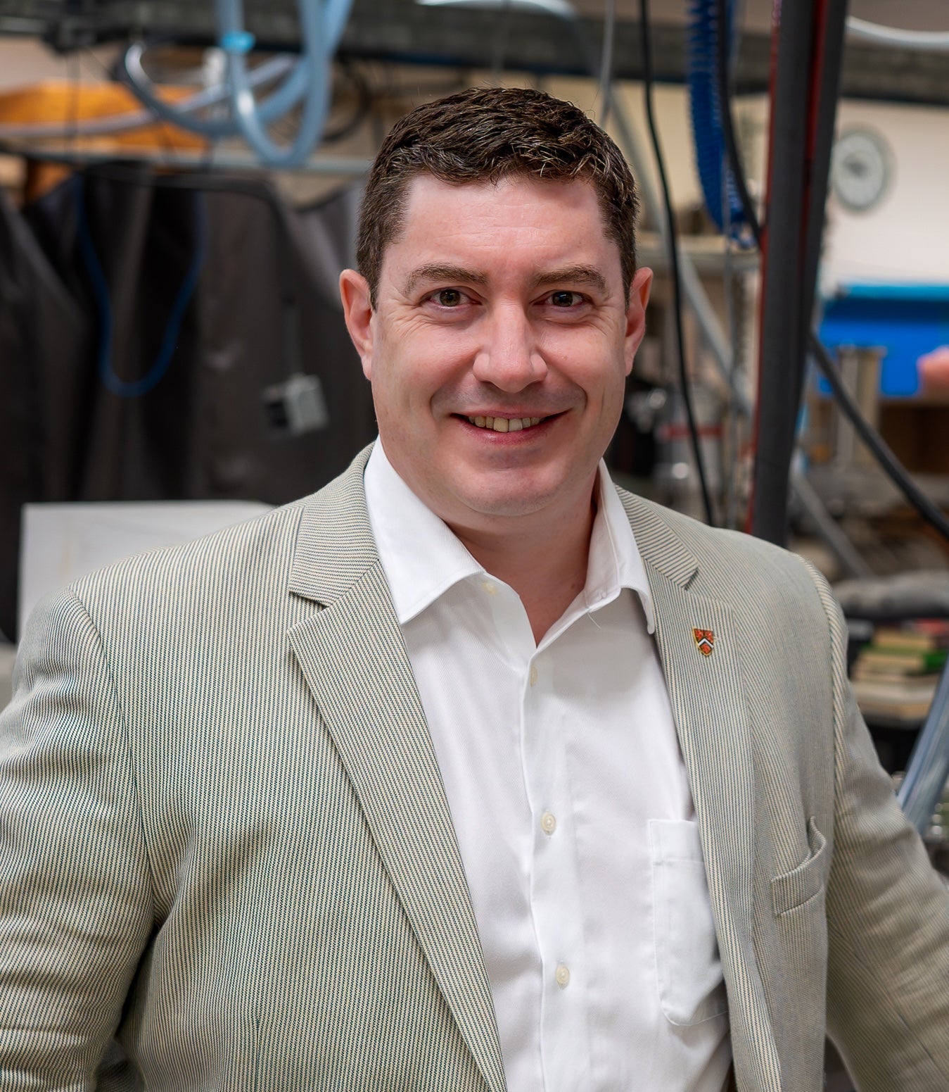 Dr. Scott Hopkins standing in a laser lab facility
