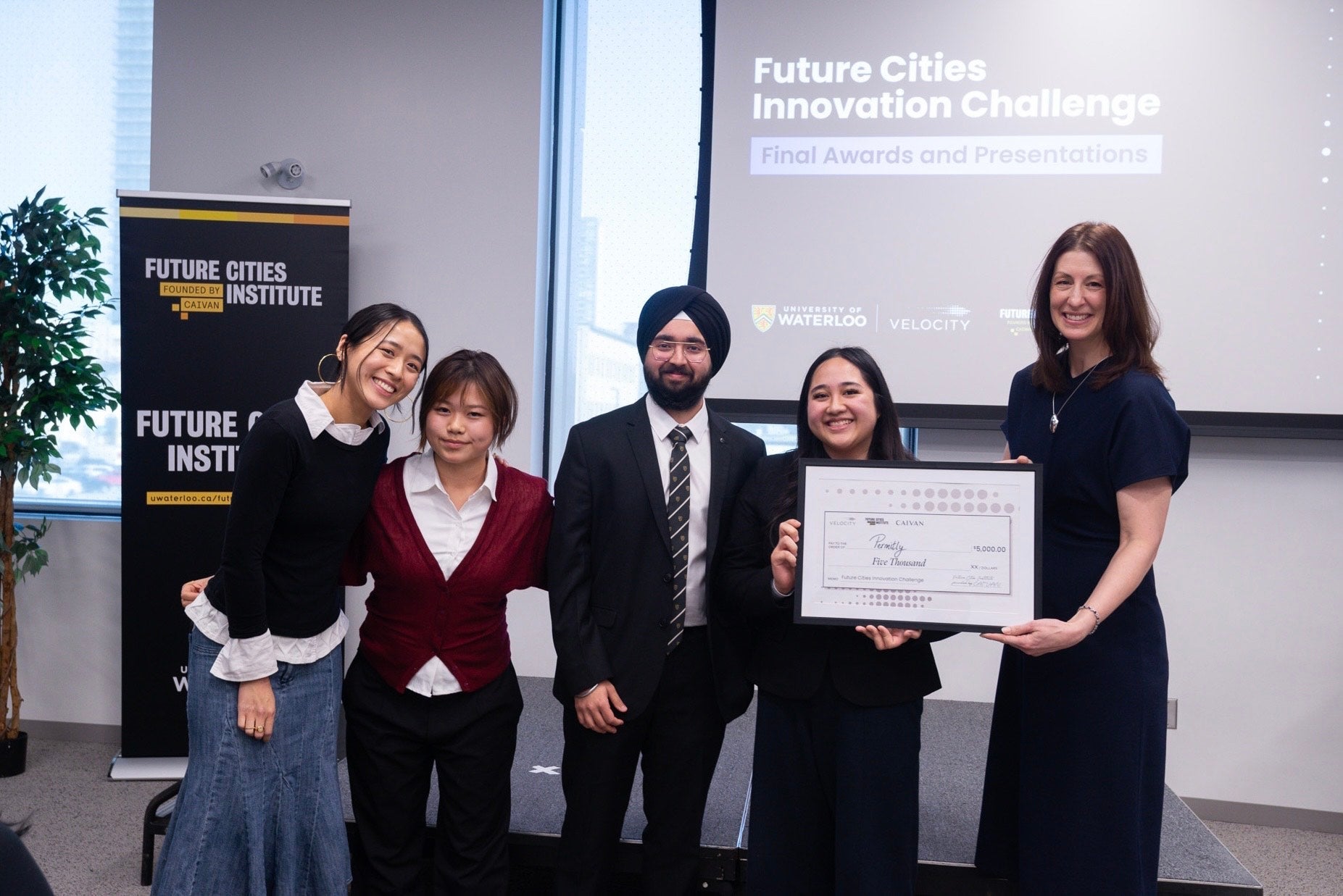 Sehaj and team receiving a framed certificate at the Future Cities Innovation Challenge