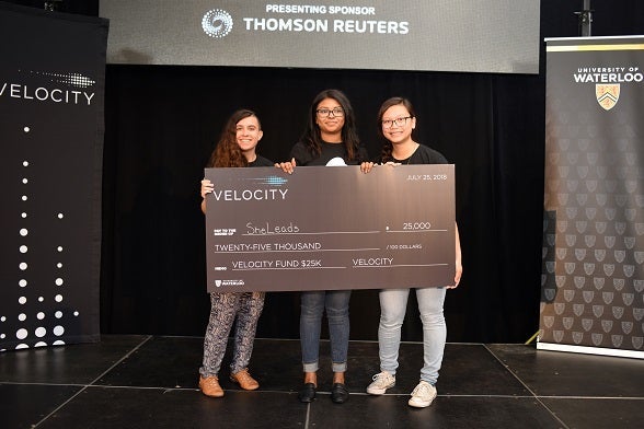 SheLeads team display their cheque.