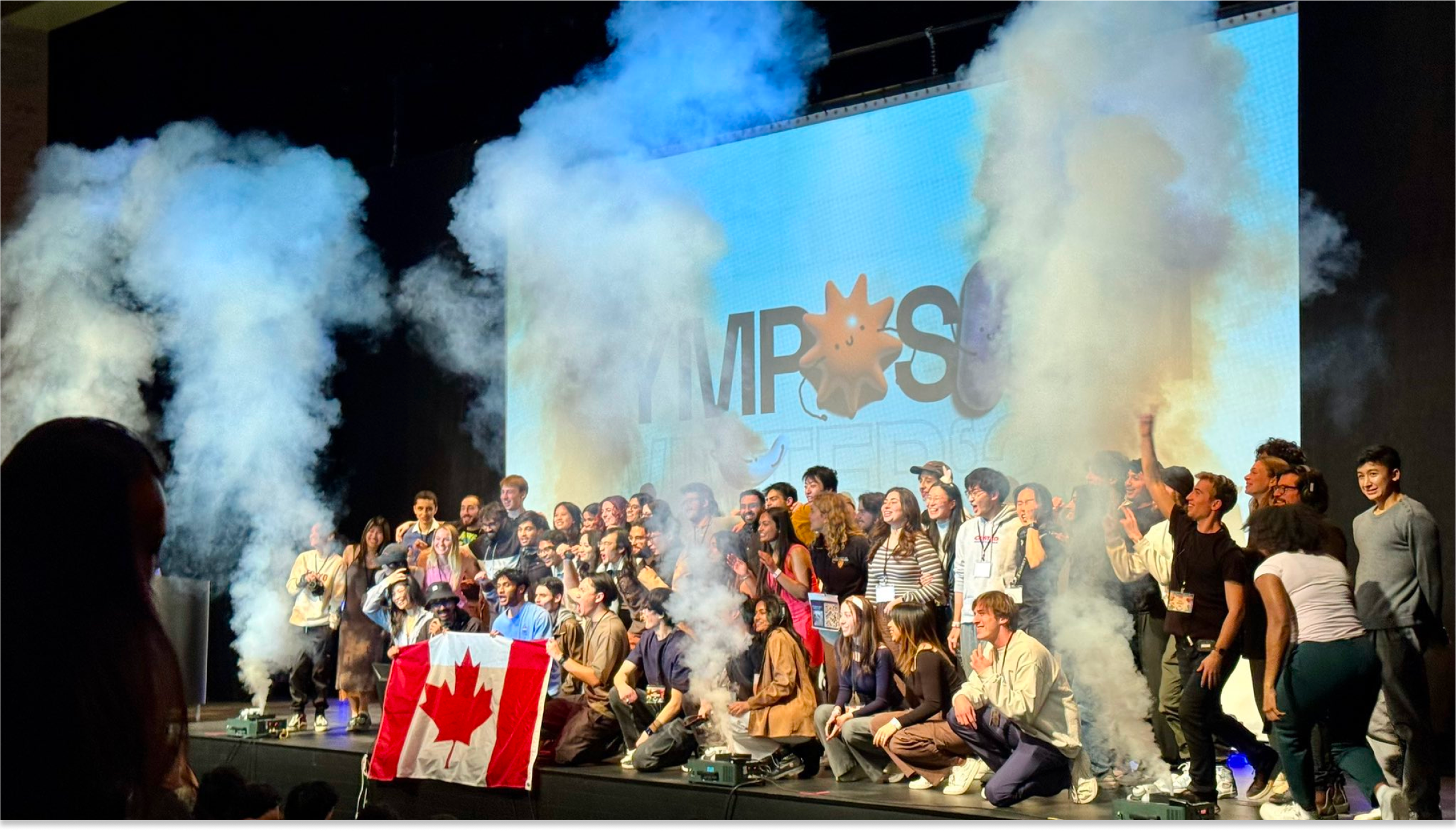 Members of Socratica celebrate on stage at their annual symposium.