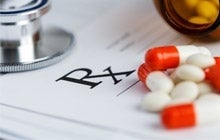 Doctor's prescription pad and medications
