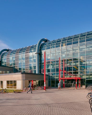 Entrance to Davis Centre with red pipes and glass window and doors in the foregroud