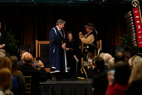Elder Henry presents Dr. Rosehart with a medallion