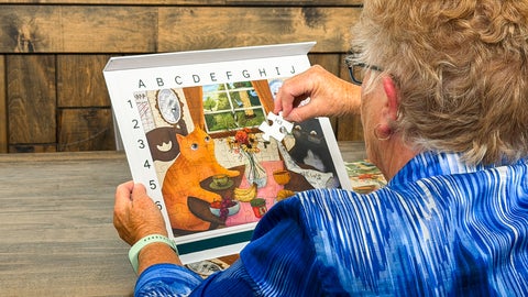 Grandmother identifying a puzzle piece to grid map on where it goes