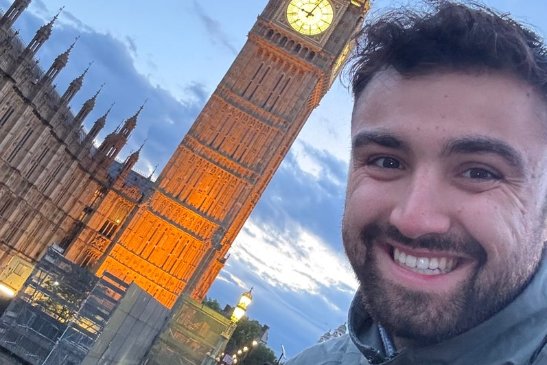 Ethan Rad posing with Big Ben in London during the evening