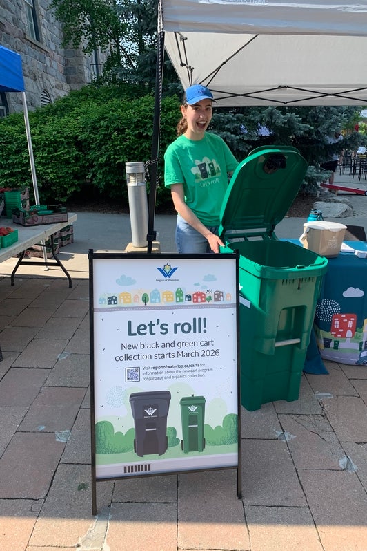 Chloe Sullivan holding a Waterloo region compost bin